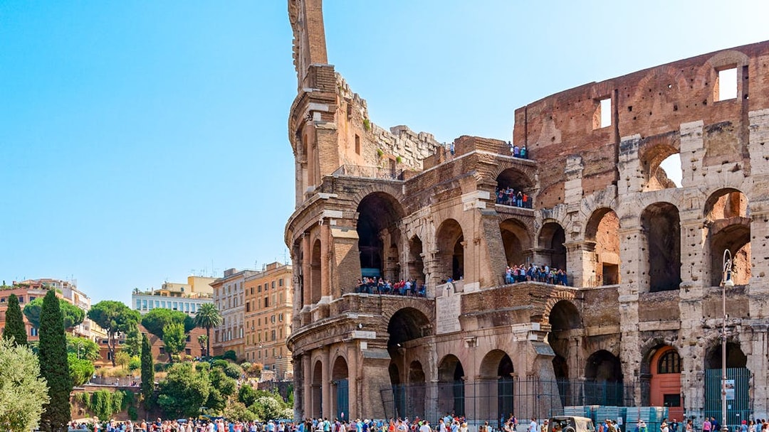 Colosseum in Rome with tourists on an express guided tour.
