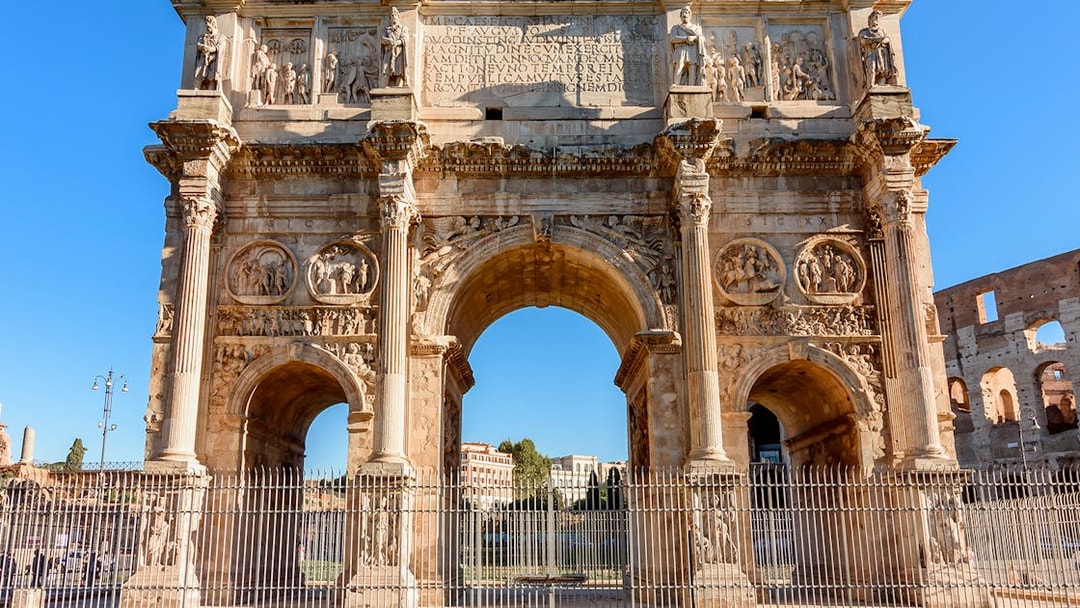 Arch of Constantine near the Colosseum in Rome, part of the guided tour with arena access.