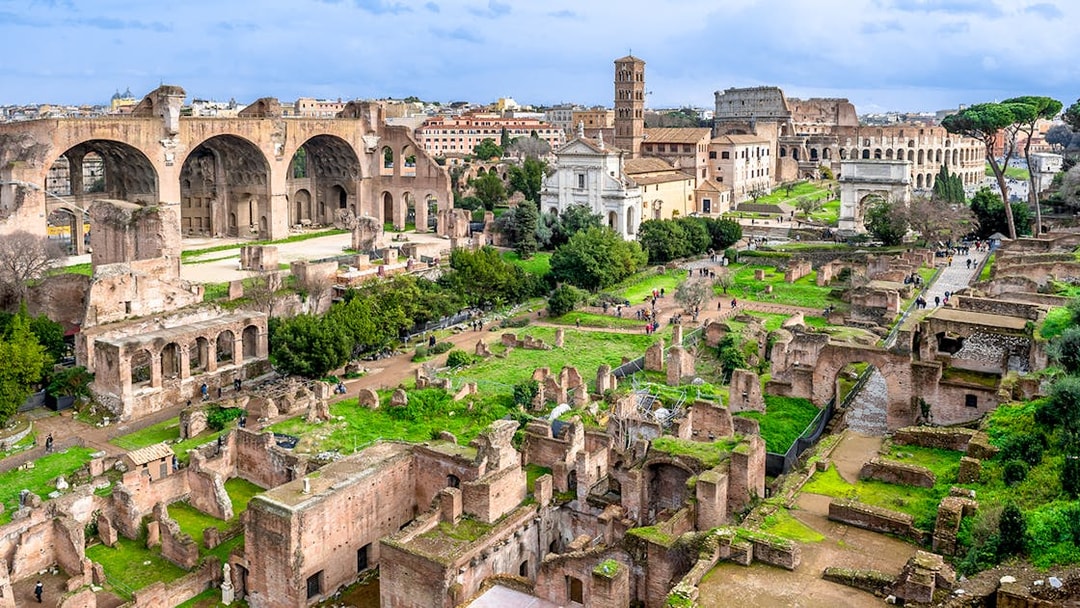 Colosseum, Palatine Hill, and Roman Forum ruins in Rome, Italy, viewed from above.