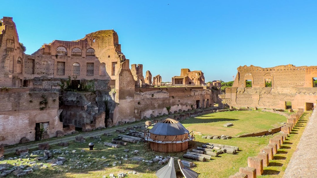 Colosseum Underground tour with views of Palatine Hill ruins on a sunny day in Rome, Italy.