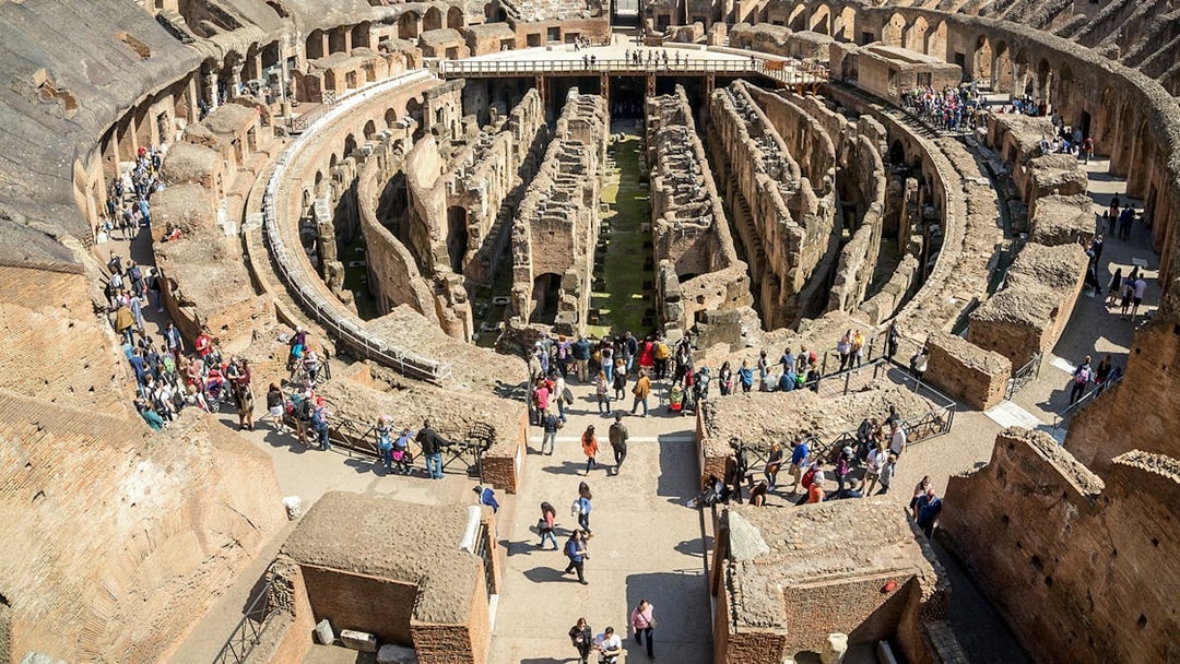Visitors exploring the first floor of the Colosseum in Rome, Italy.