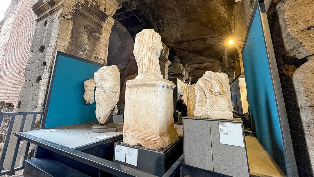 Ancient Roman statues displayed inside the Colosseum Museum in Rome.