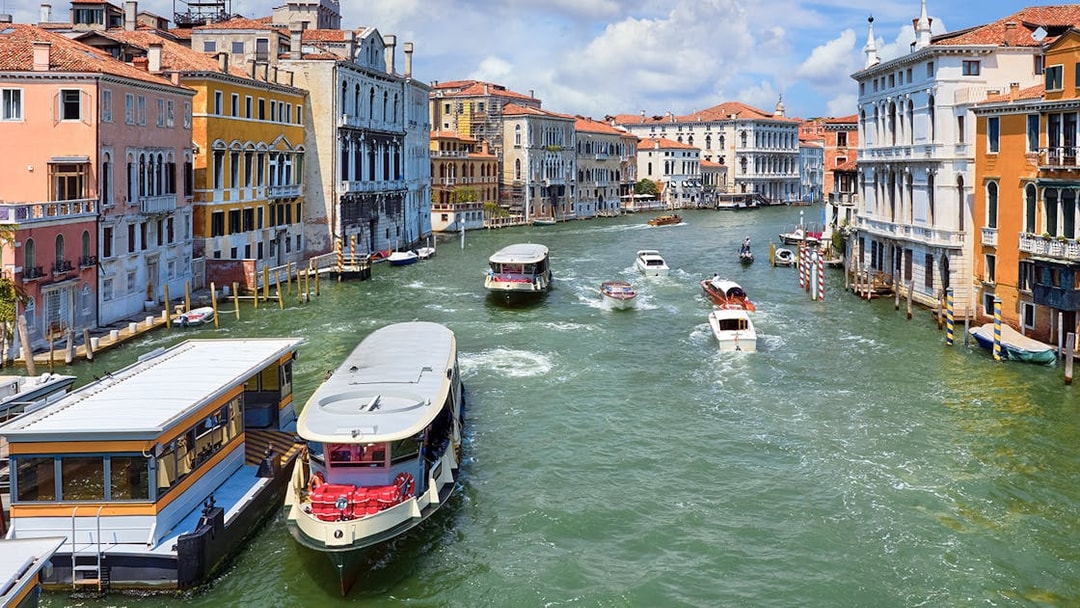 Vaporetto on Grand Canal in Venice, Italy with historic buildings in view.