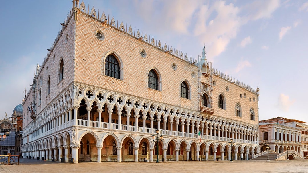 Doges Palace in Venice with Gothic architecture and arched colonnades.