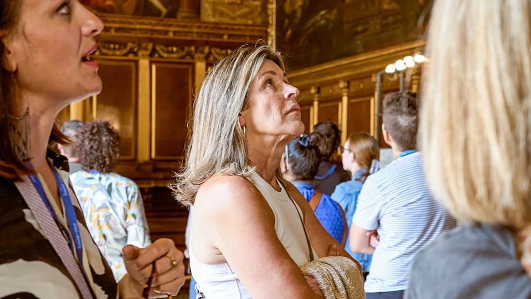Visitor observing art during a tour at Doge’s Palace, Venice.