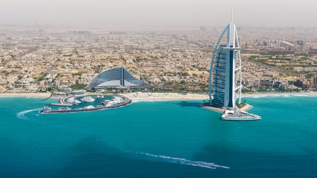 Dubai skyline with Burj Al Arab and coastline from helicopter view.