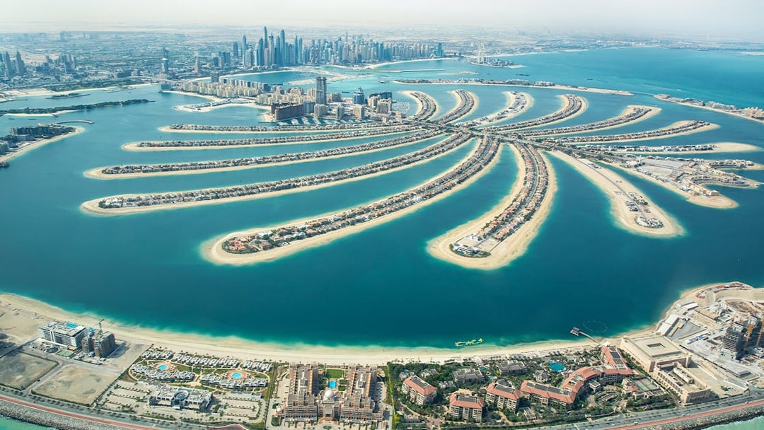 Aerial view of Palm Jumeirah in Dubai, showcasing the iconic palm-shaped island and city skyline.