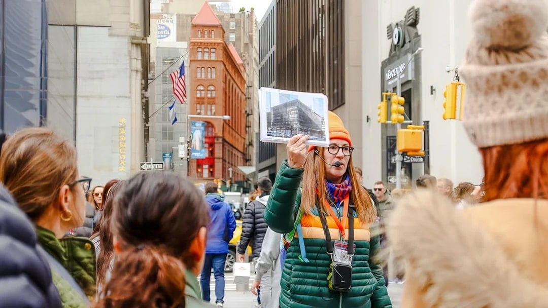 Tour guide in New York City showing a photo of the original World Trade Center.