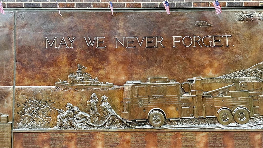 FDNY Memorial Wall with firefighters and fire truck relief, New York City.