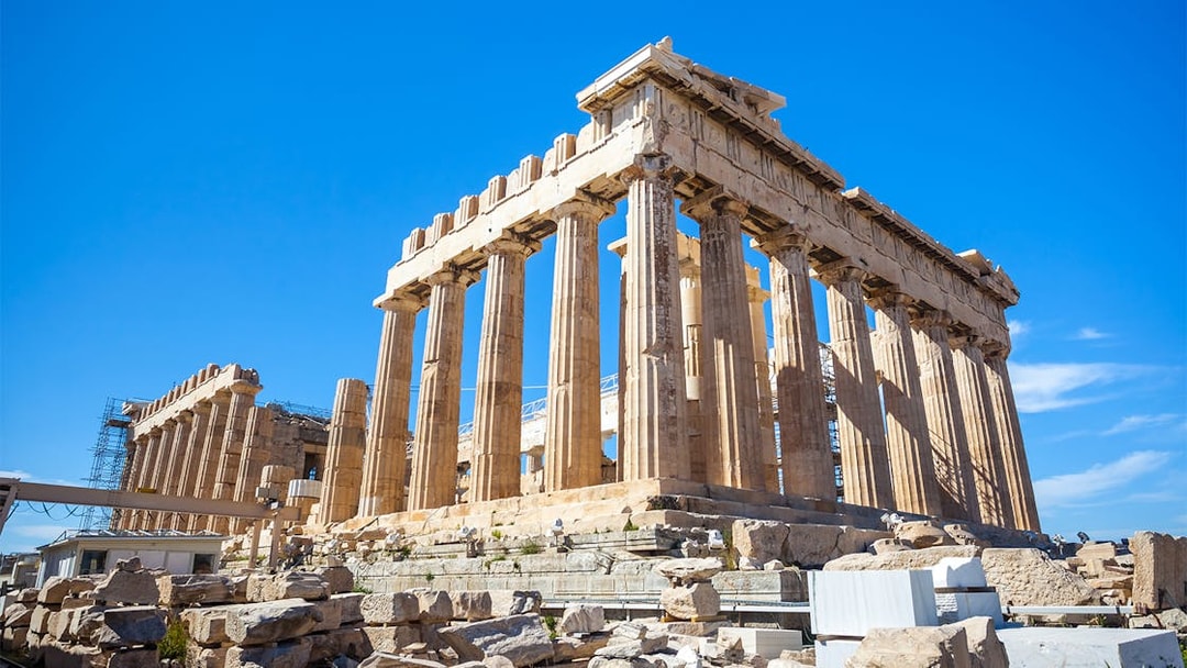 Parthenon temple on the Acropolis in Athens, Greece, under a clear blue sky.