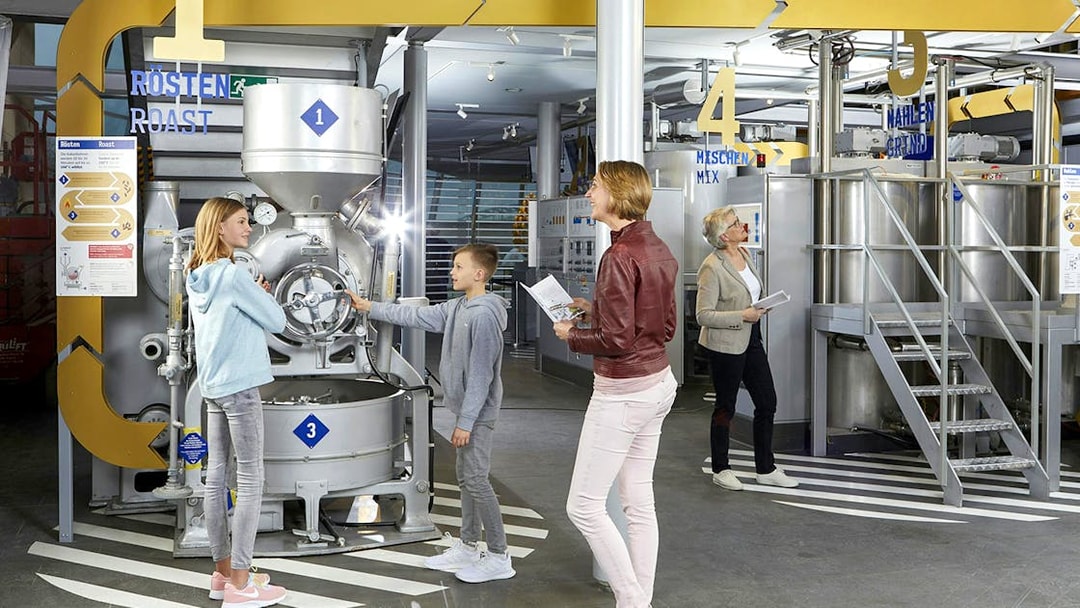 Visitors exploring machinery at Chocolate Museum Cologne.