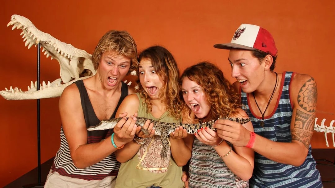 Visitors holding a baby crocodile at Crocosaurus Cove, Darwin.