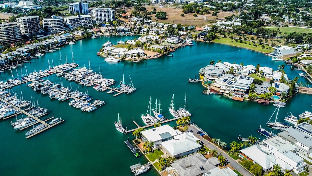 Aerial view of Darwin marina with boats and waterfront homes, part of Big Bus Darwin tour.