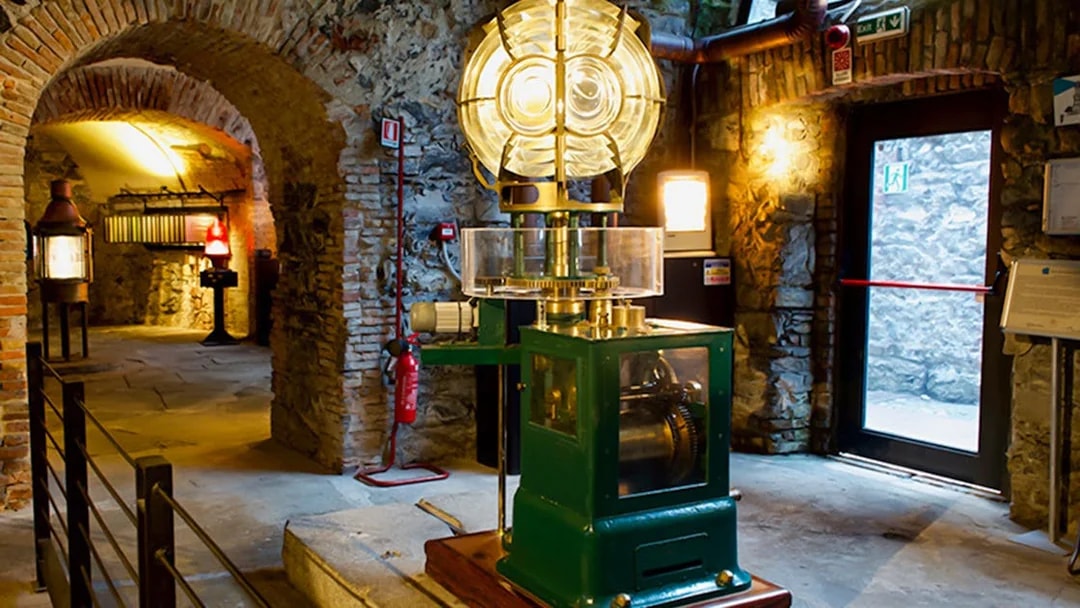 Lighthouse interior with historic lens and machinery, Genoa.