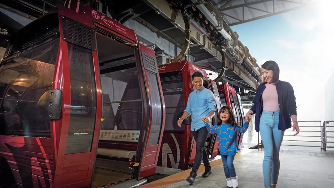 Family boarding cable car at Genting Awana SkyWay, Malaysia.