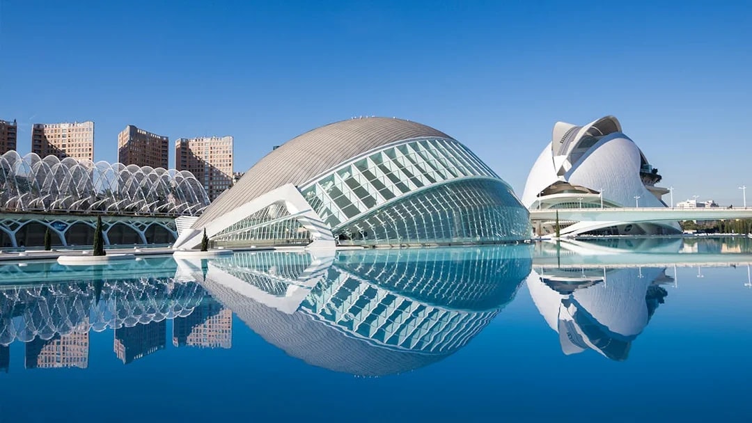 Hemisfèric and Science Museum in Valencia reflected in water.