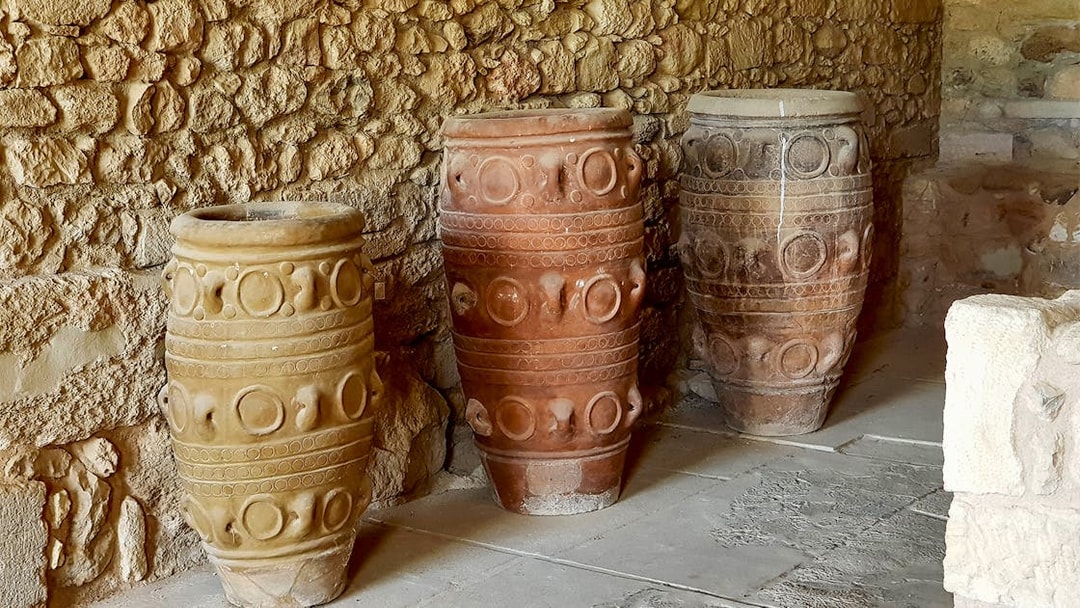 Ancient storage jars inside Knossos Palace, Crete, showcasing Minoan pottery design.