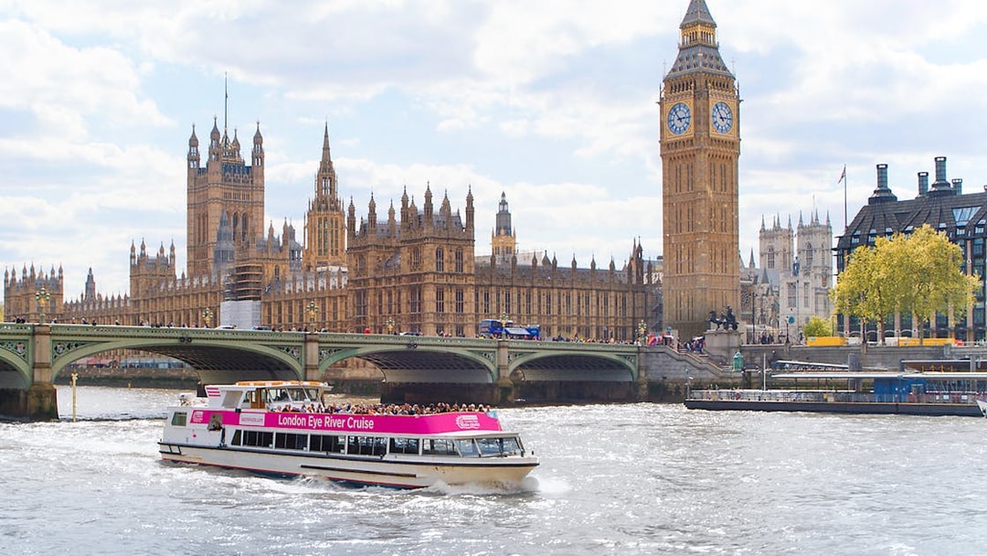 River cruise boat passing Big Ben and Houses of Parliament in London.