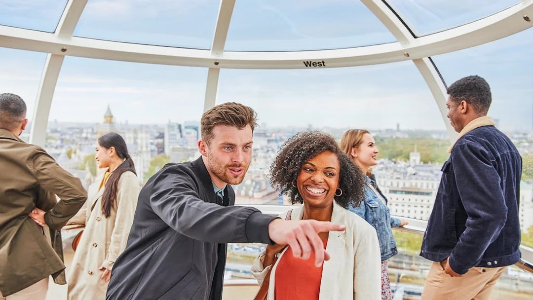 Visitors enjoying the view from the London Eye capsule.