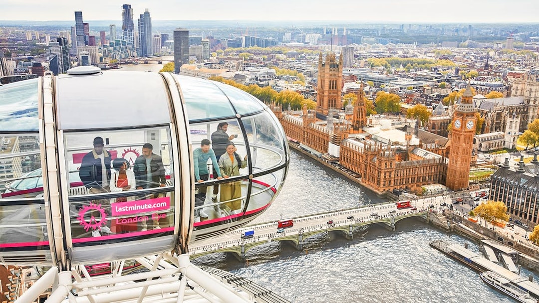 Visitors inside a London Eye capsule overlooking the River Thames and Big Ben.
