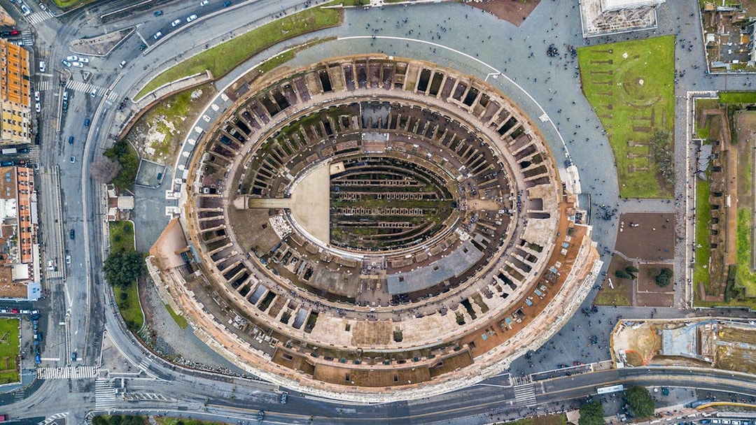 Aerial view of the Colosseum in Rome, Italy, highlighting its ancient architecture.