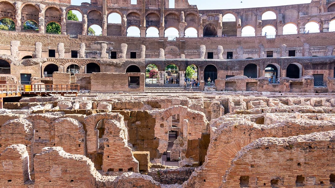 Gladiator arena ruins inside the Colosseum, Rome, showcasing ancient architecture.