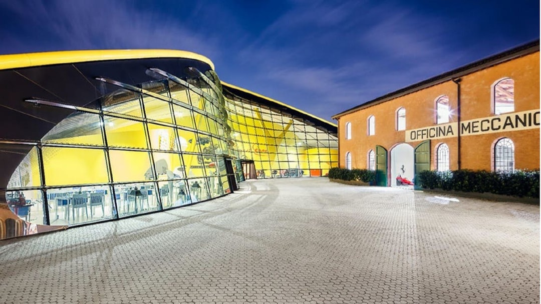 Maranello Ferrari Museum exterior with modern glass facade and historic building.