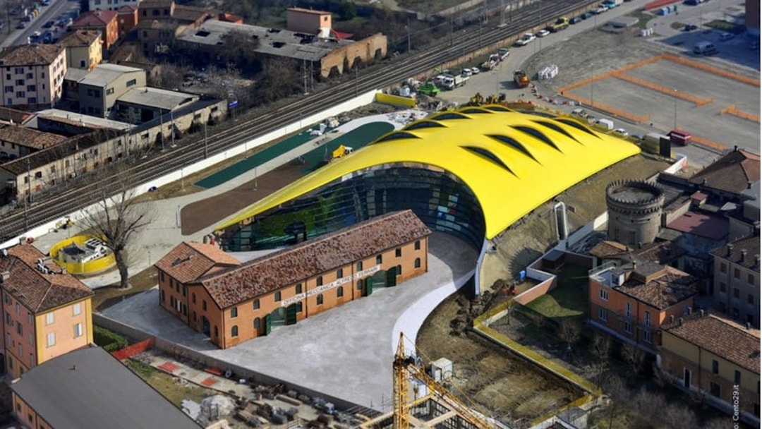 Aerial view of Modena Enzo Ferrari Museum with its distinctive yellow roof in Modena, Italy.