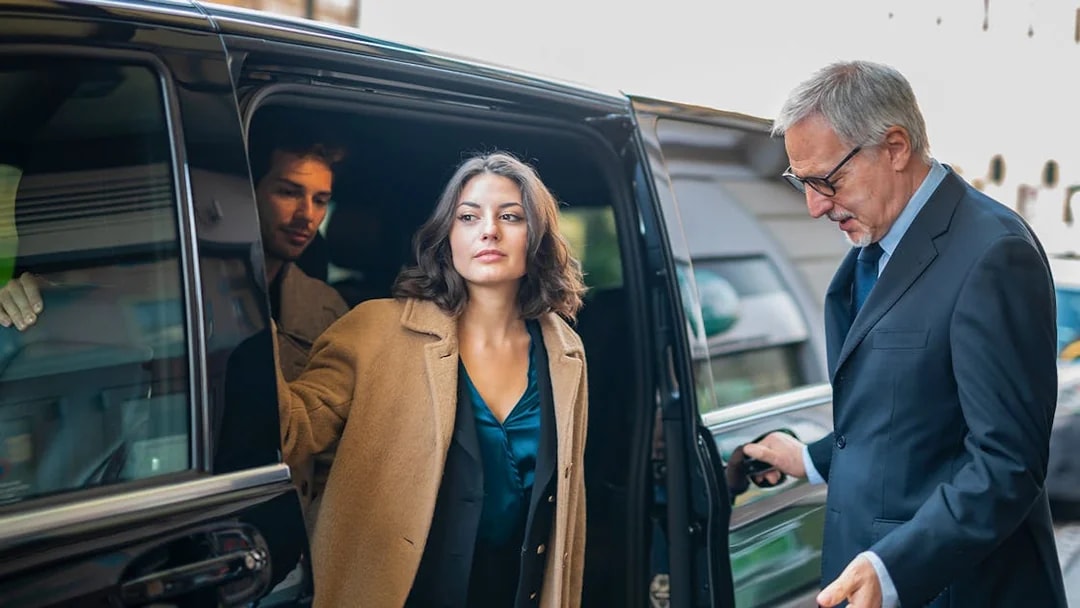 Shuttle service passengers exiting vehicle in Monreale, Palermo.