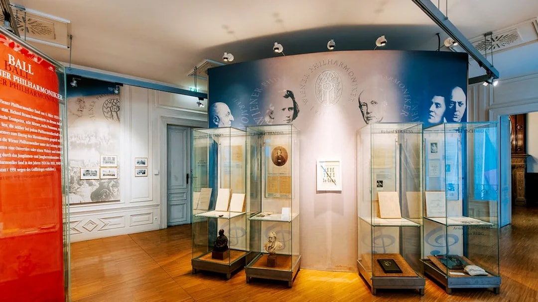 Exhibit displays at Haus der Musik featuring historical music documents and composer portraits.