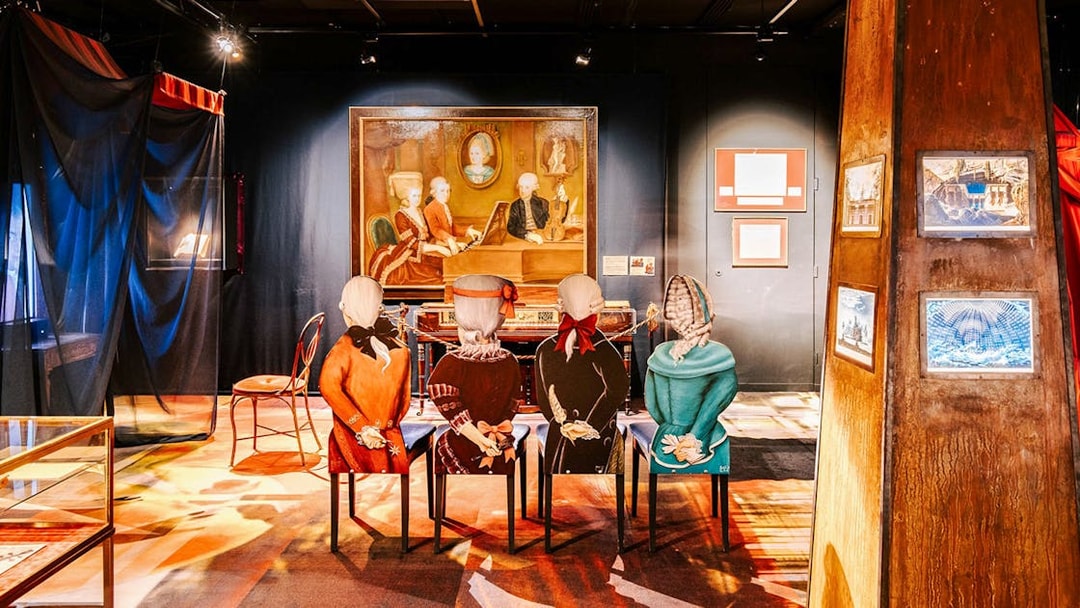 Guests exploring an exhibit with historical figures at Haus der Musik, Vienna.