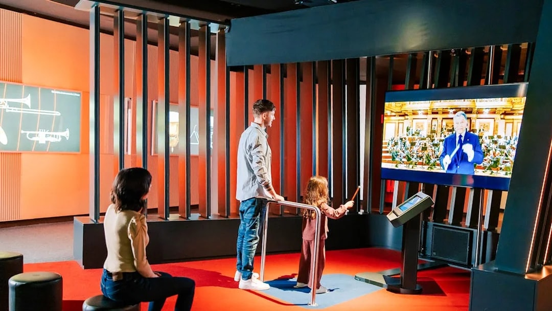 Guests interacting with a virtual conductor exhibit at Haus der Musik, Vienna.