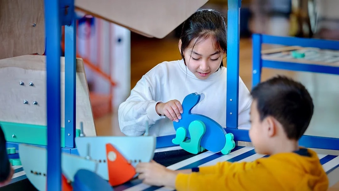 Children engaging with interactive exhibits at NEMO Science Museum.