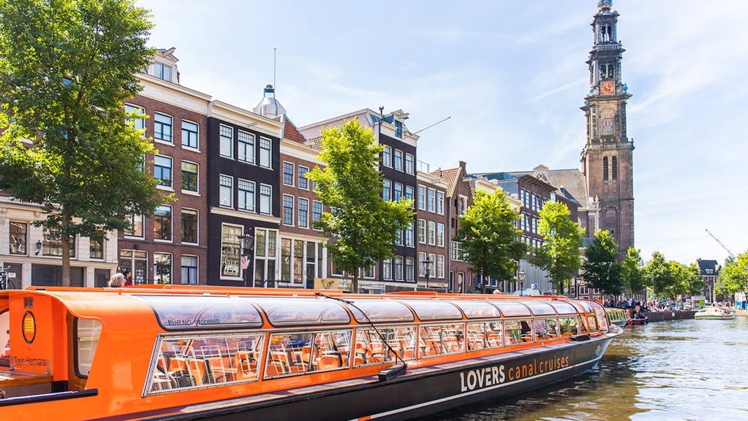Hop-on hop-off canal boat near Westerkerk in Amsterdam.