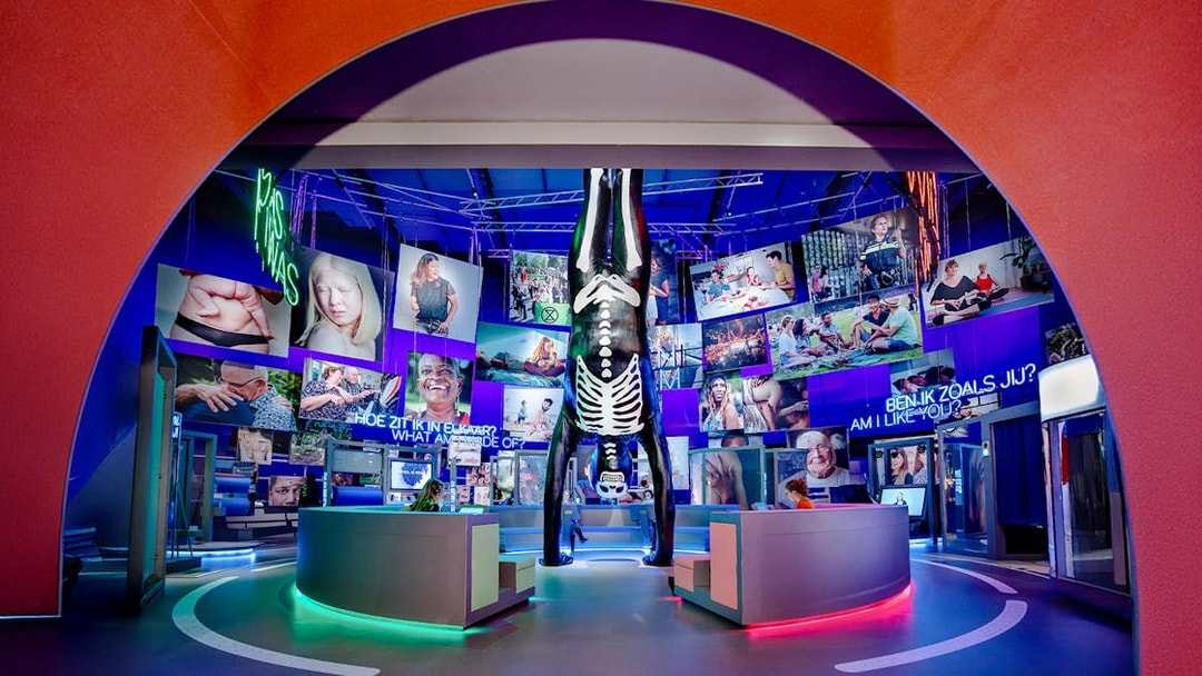 Visitors engaging with human biology exhibit, interacting with models and digital screens.