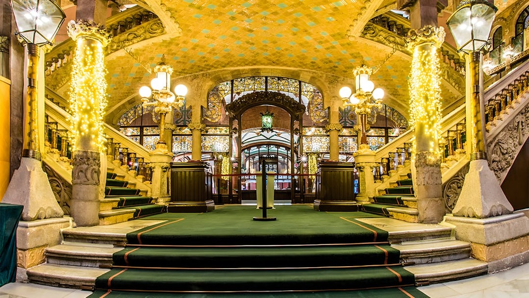 Palau de la Música Catalana interior with ornate staircase and stained glass.
