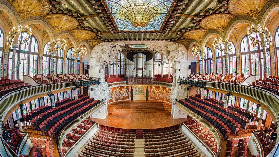 Concert Hall interior at Palau de la Musica Catalana, Barcelona, featuring stained glass and ornate architecture.