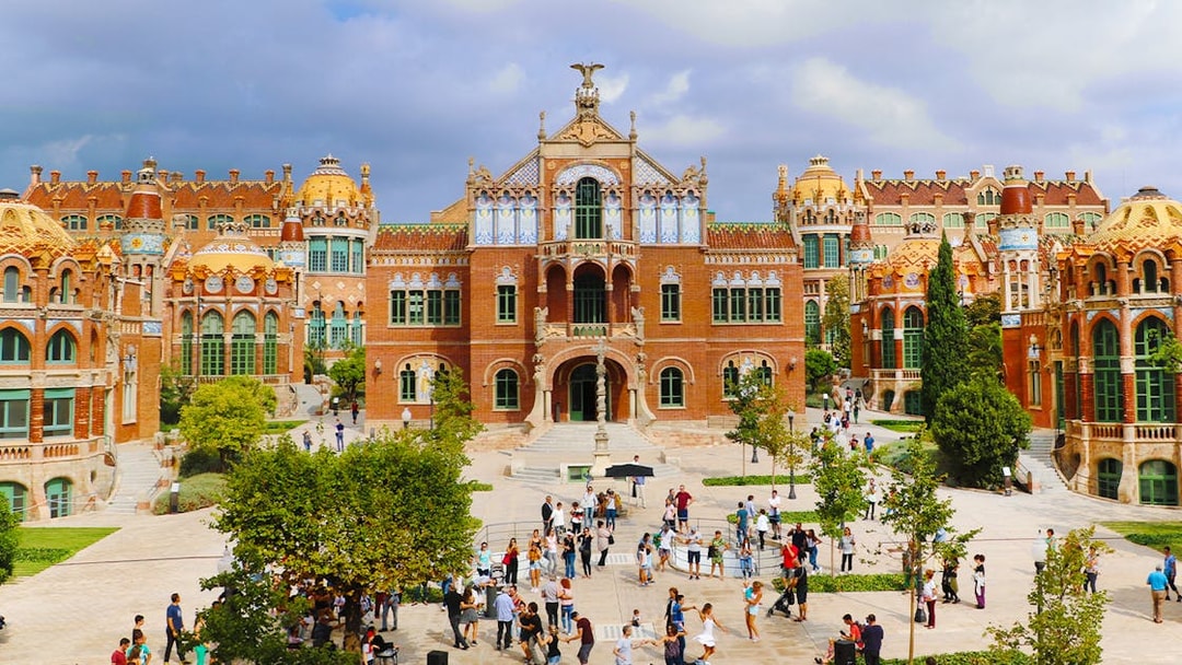 Sant Pau historical site in Barcelona with visitors exploring the courtyard.