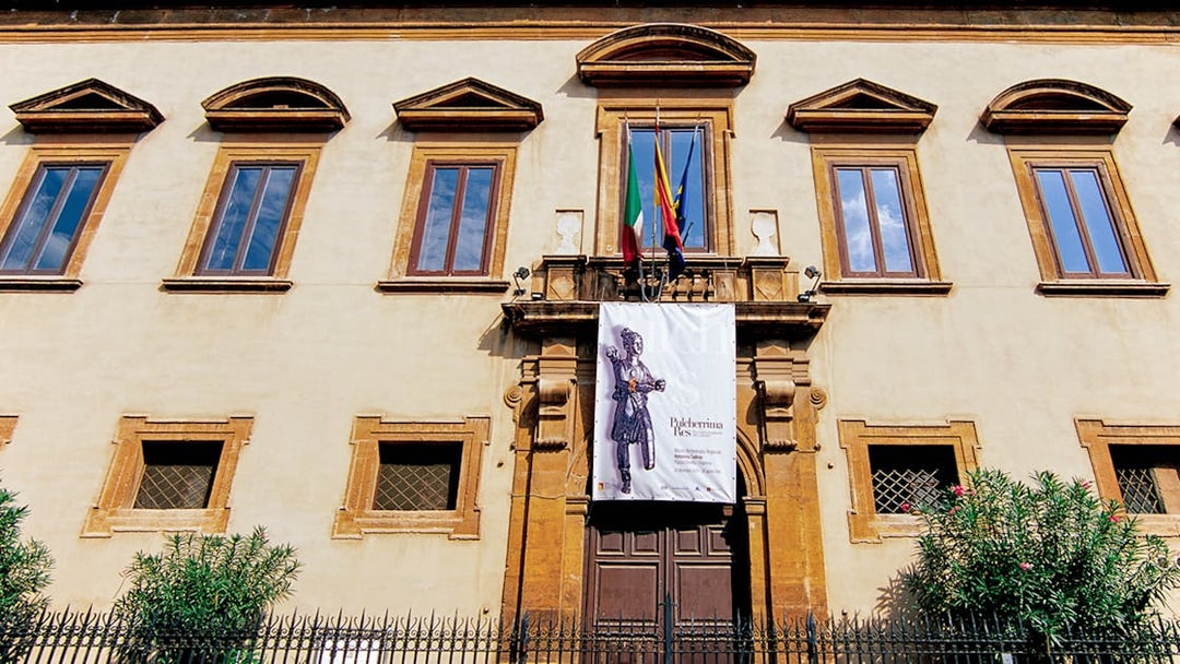 Facade of Antonino Salinas Archaeological Museum in Palermo with entrance banner.