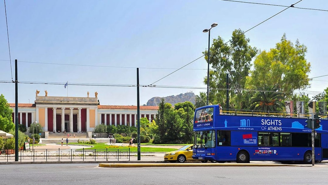 Blue tour bus in front of the National Archaeological Museum, Athens, on Hop on Hop off Classic Tour.
