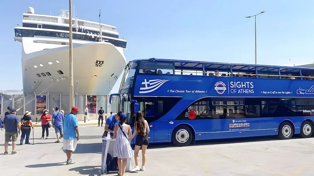Athens hop-on hop-off bus near cruise ship with tourists boarding.
