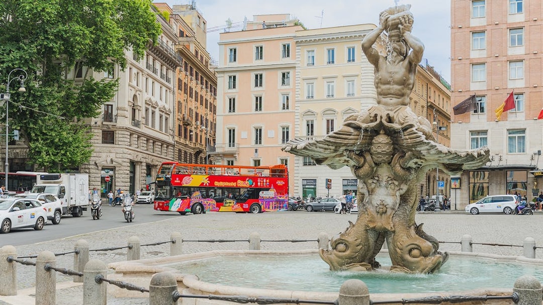 City sightseeing bus near Fontana del Tritone in Rome.