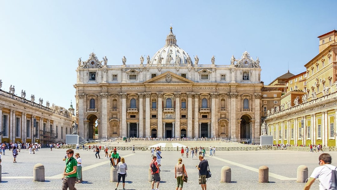 Basilica of Saint Peter facade with tourists in Vatican City, Rome.