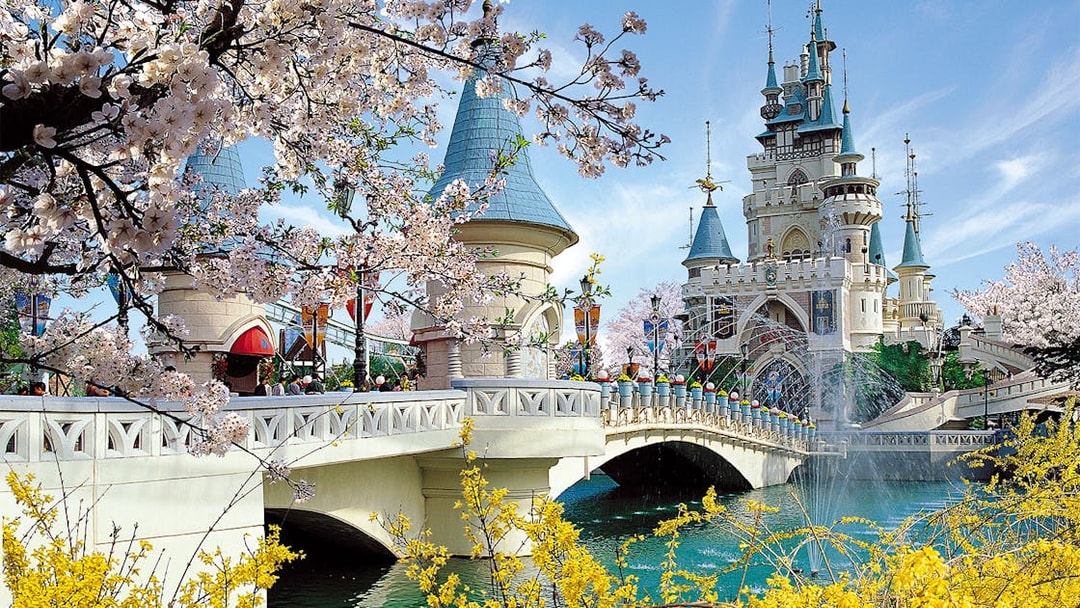 Lotte World castle with cherry blossoms and bridge in Seoul, South Korea.
