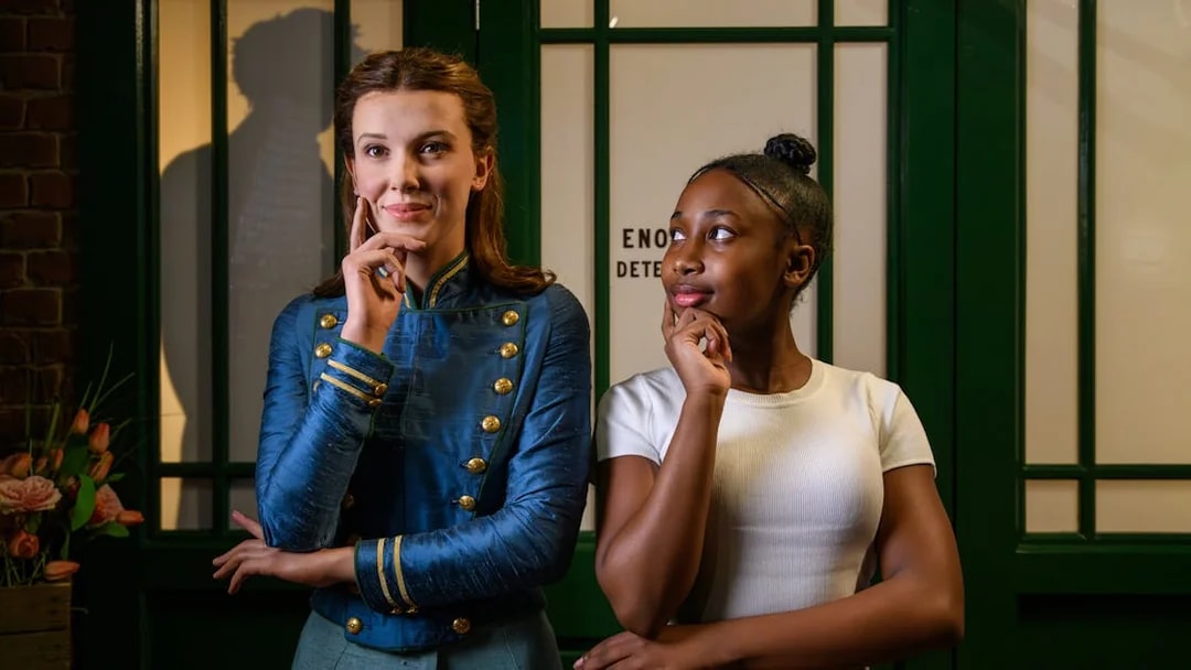 Enola Holmes wax figure with visitor at Madame Tussauds London.