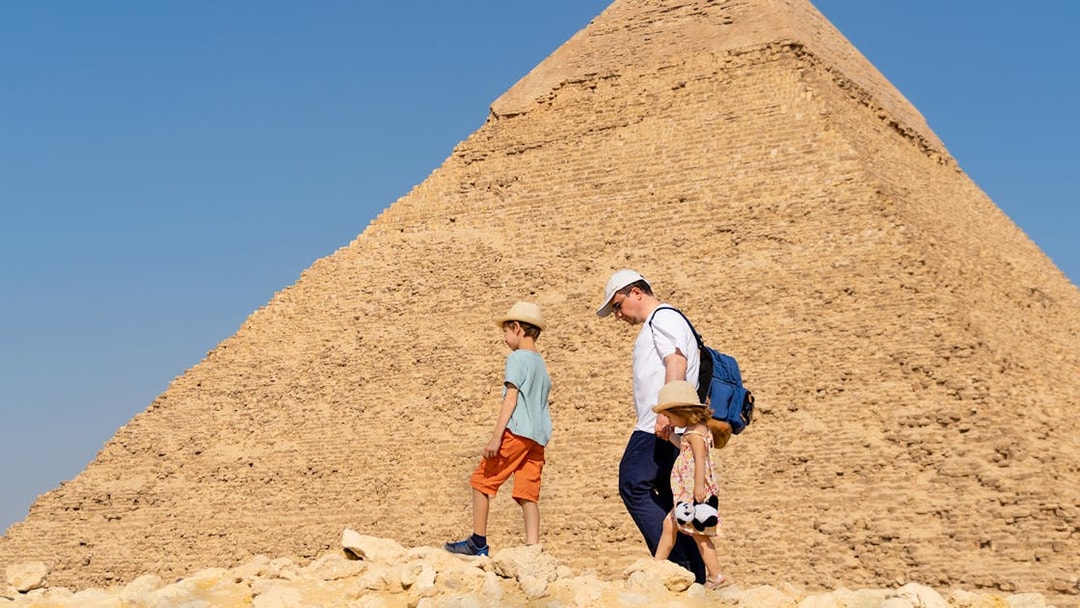 Family walking near the Pyramid of Giza, Egypt.