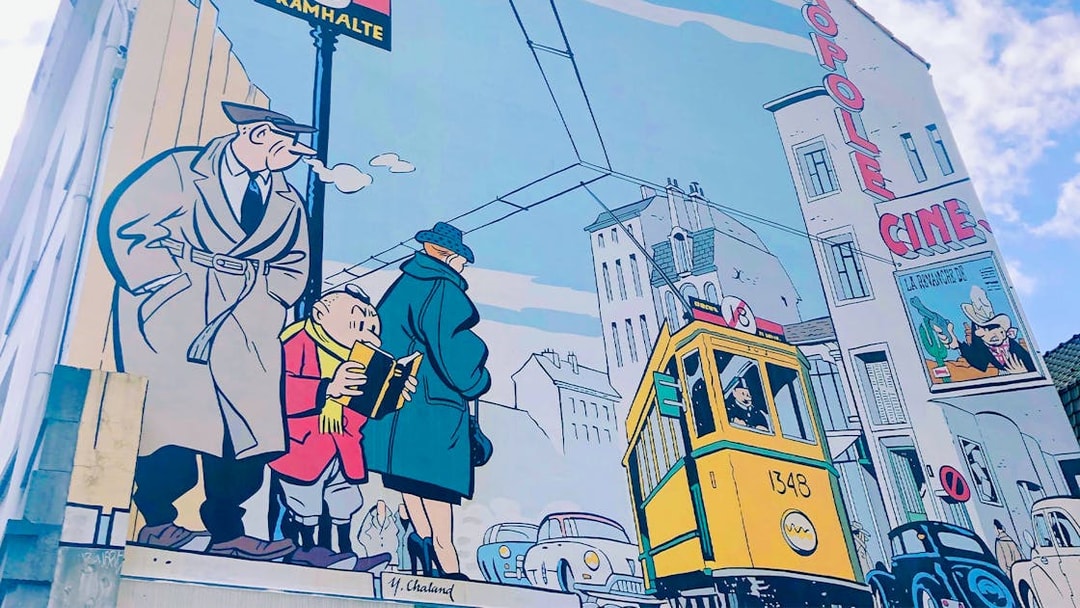 Comic-style mural in Brussels featuring a tram and pedestrians, highlighting urban life.