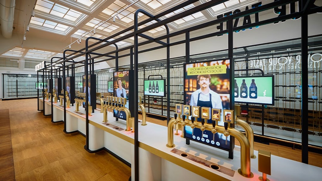 Beer tasting taps and digital screens inside Belgian Beer World, Brussels.