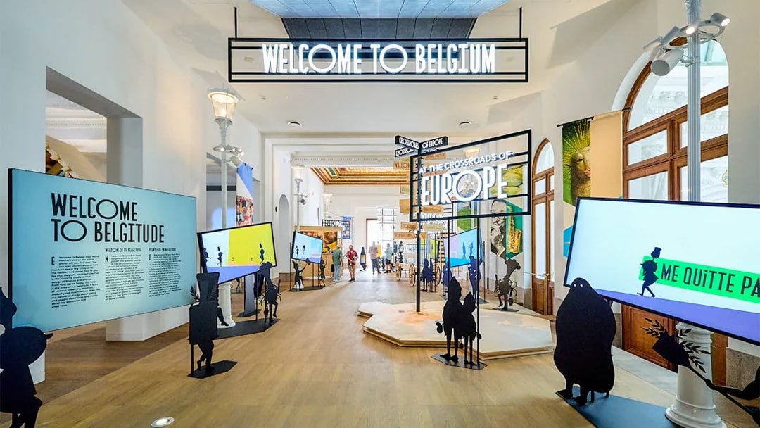 Brussels museum exhibit with "Welcome to Belgium" sign, part of hop-on hop-off bus tour.
