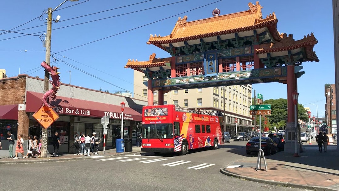 Seattle City Sightseeing bus under Chinatown gate on 5th Ave.